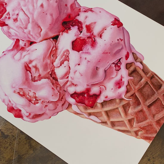Strawberry Scoops ice cream cone art print by Kim Testone, featuring three pink scoops of strawberry ice cream, with bits of fruit in it, in a cone, set against a contemporary white background.